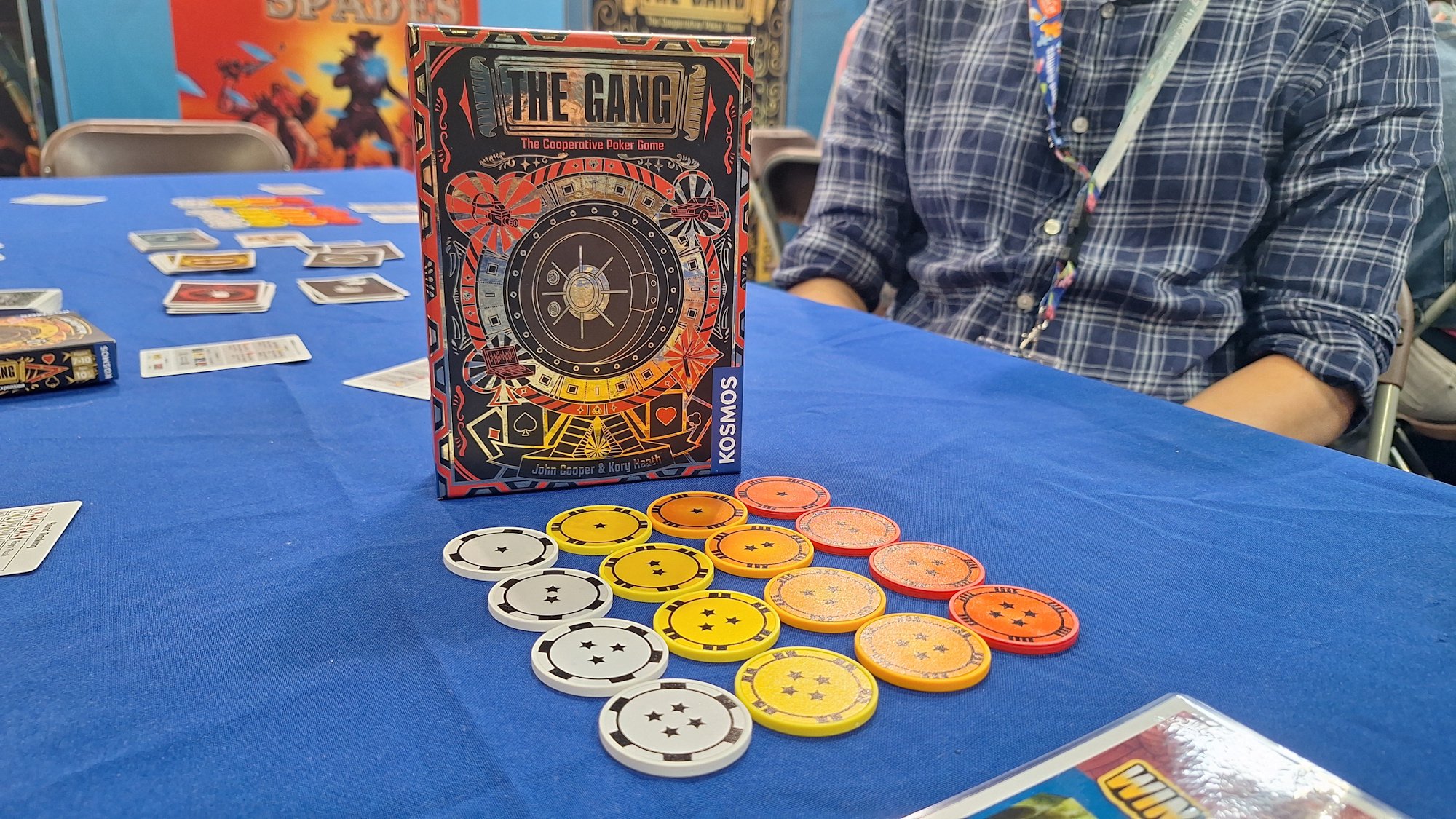 The Gang board game box with poker discs arranged in front of it