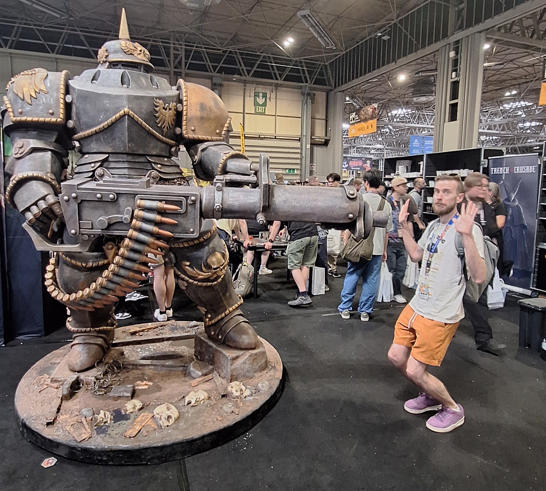 A giant statue of an armored man holding a gun, he points it at me and dI look terrified with hands held up in surrender