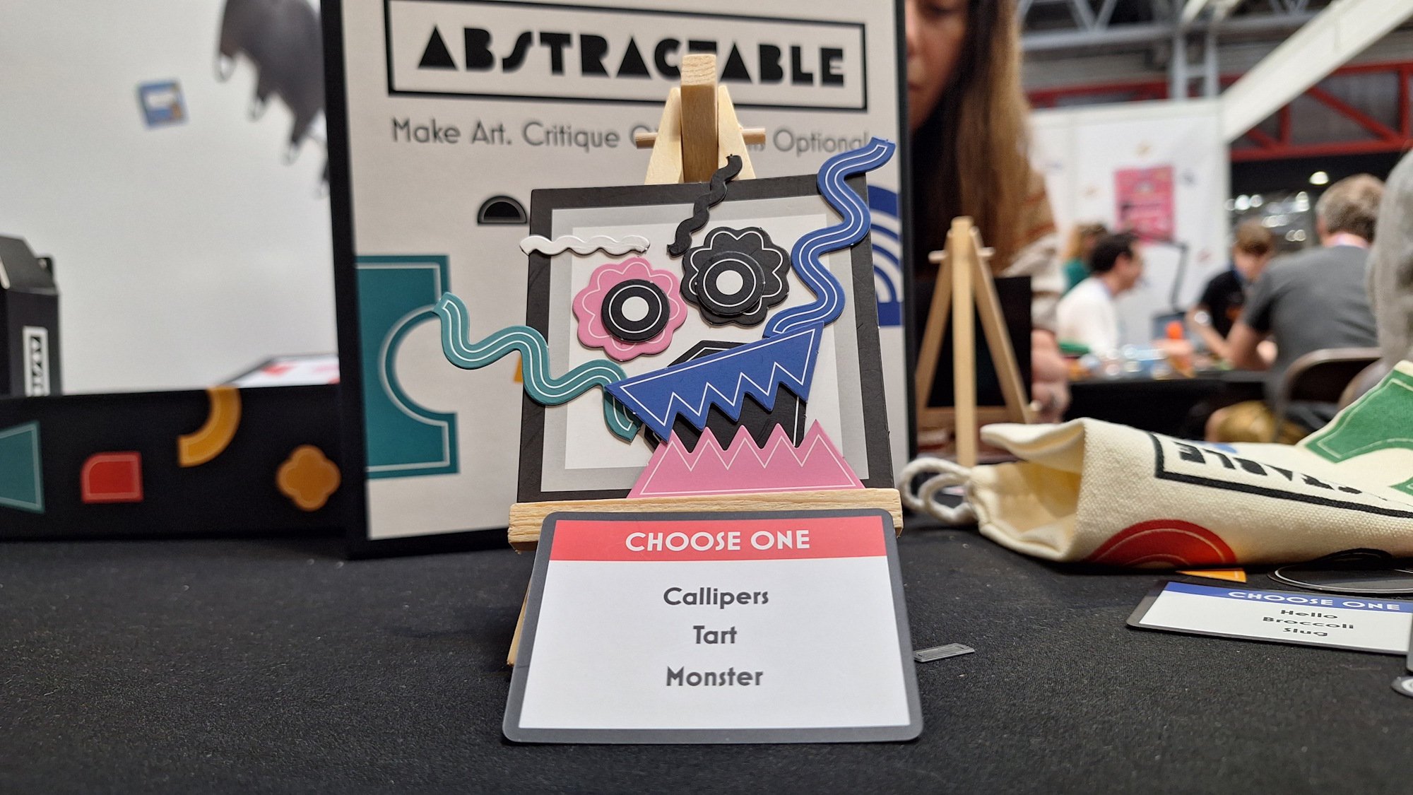 A series of shapes arranged to make a monster face in Abstractable, a board game at UKGE 2026